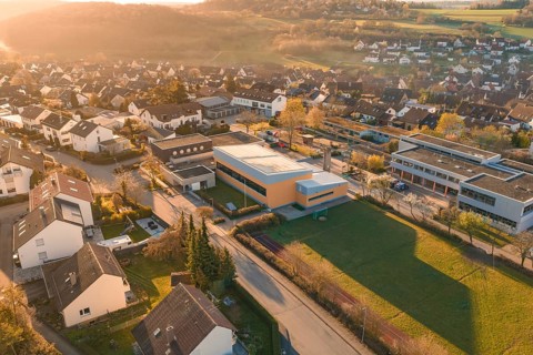 Residential and school buildings in a village setting with autumn surroundings, Schlehengäuschule,