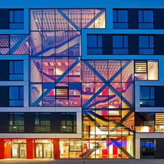 Bochum University seminar building in the evening with an eye-catching staircase with a signal red
