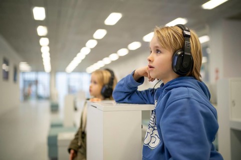 Interior shot, boy, 6 years, and girl, 4 years, blonde, headphones, listening and viewing media
