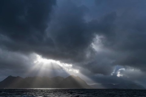 Sunbeams over coastal landscape and sea, Lofoten, Nordland, Norway, September 2020