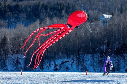 Kite flying over the frozen Saint Mauricie river. Festival Festi-Volant. Canada's biggest winter