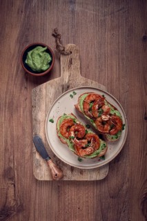Sandwiches with avocado and caramelized shrimp, micro-greens, breakfast, on a plate, top view,