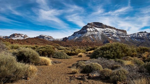 An impressive mountain landscape with clear sky lines and dense vegetation on the ground, Teide,