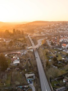 Aerial view of a country road with bridge and surrounding village at dusk, Weil der Stadt,