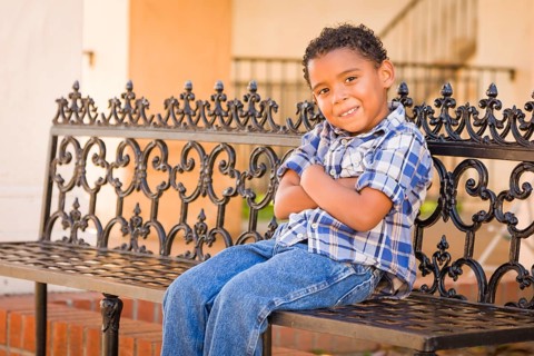Handsome African American and Mexican Boy Sitting on Park Bench