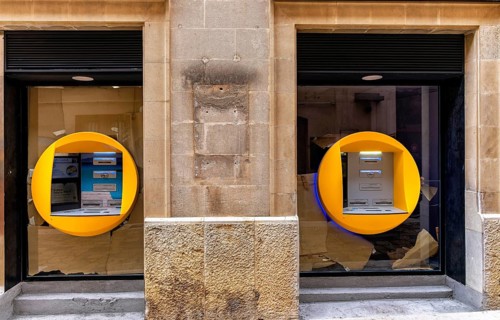 Caixa banking house with ATMs in the small town of Pollenca, Majorca, Balearic Islands, Spain