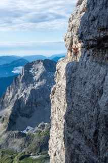 Climbers on a rock band, Bocchette Centrale band trail, via ferrata in the Brenta Mountains,