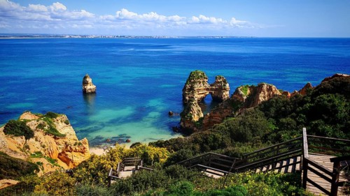 Wooden staircase and platform with views of spectacular rocks and the sea, Praia do Camilo, Lagos,