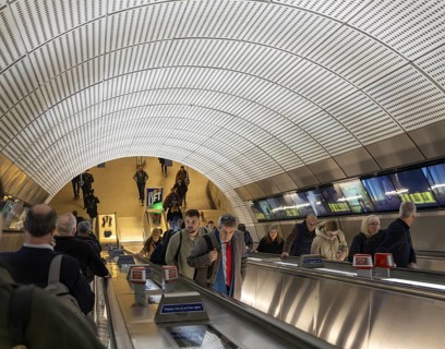 People on escalator Elizabeth Line, Liverpool Street underground railway station, London, England,