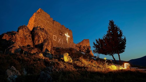 Castle ruins with illuminated cross in the evening, a tree next to it, quiet ambience, Archangelos,
