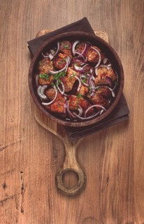 Fried meat, pork kebab, ketsi in a clay pan, with red onions and herbs, homemade, no people