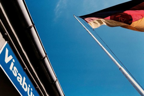 Historical photo of a GDR flag at a visa office at the former Checkpoint Bravo, Berlin, 1990,