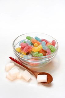 Lots of colorful jelly candies and sugar cubes, sugar consumption