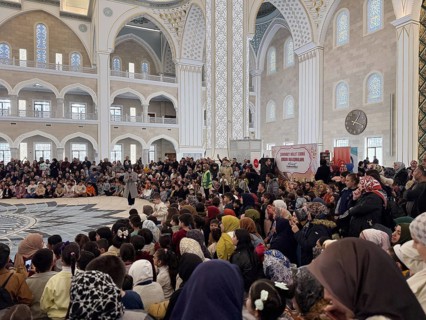 Dozens of Muslim children participate in indoor entertainment event inside a grand mosque during