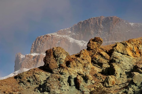 Erosion shaped rocks against snow-covered mountain backdrop, Teide, Parque Nacional del Teide,