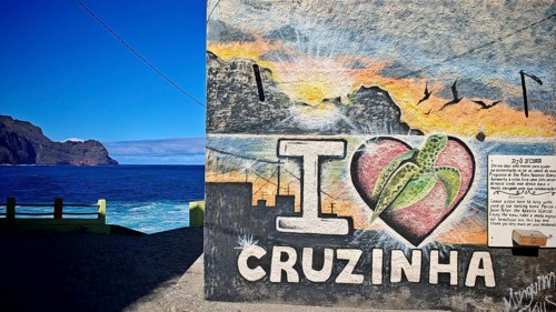 Wall with graffiti 'I Love Cruzinha' and a coastal scene in the background, Cruzinha, hiking, Santo