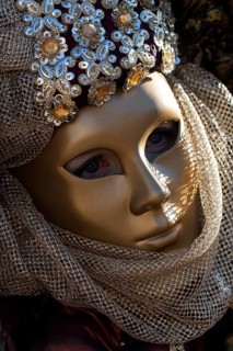 Venetian carnival mask and costumes at the Venetian fair on the historic market square,
