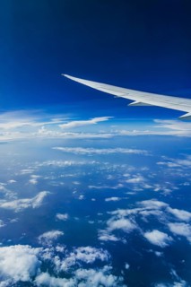 View from the aircraft window during a flight over India with the airline Etihad. Blue sky and