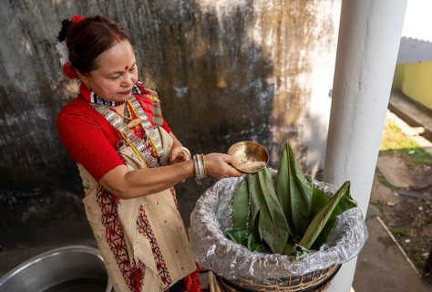 A Mising woman prepares traditional rice beer 'Aapong' during Ali-Aye-Ligang festival in Guwahati,