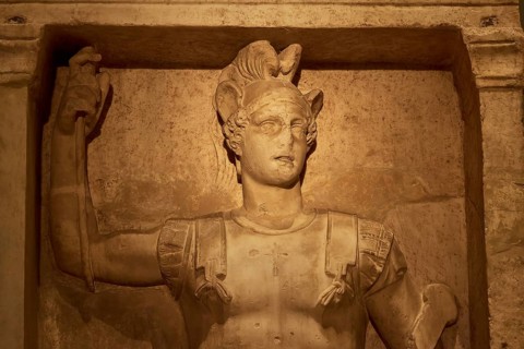 Relief of an ancient Roman warrior statue made of marble with raised arm, Patras Archaeological