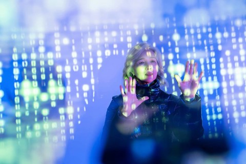 An elderly Asian woman explores the digital realm of the metaverse, interacting with virtual