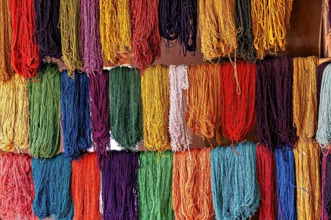 A variety of colorful threads arranged in rows create a lively and colorful appearance, colorful