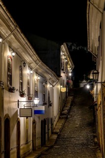 An alley in the historic city of Ouro Preto illuminated by lanterns at night, Ouro Preto, Minas