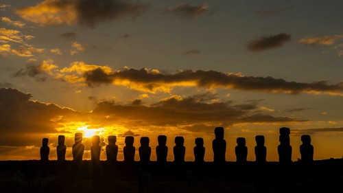 Silhouette moai statues placed in a row, sunrise with cloud vibes, Ahu Tongariki, Easter Island,