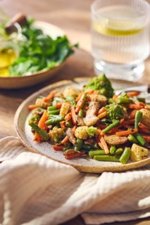 Plate of stir-fried mixed vegetables with green beans, carrots, baby corn, romanesco and mushrooms