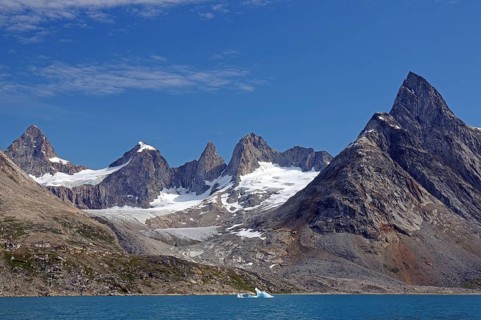Impressive mountain range with snow-capped peaks on the water, Tiniteqilaaq, Tasilaq, Arctic,