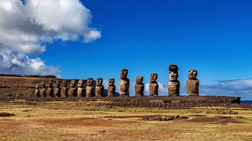 Row of Moai statues on a platform against a clear sky, The Moai statues on Easter Island in the