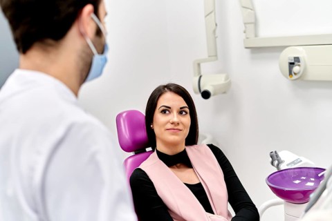 A patient discusses options for facial cosmetic surgery with a doctor in a modern clinic, focusing