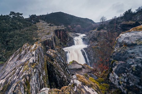 A majestic view of Cascada del Aljibe in Guadalajara, Spain, showcasing the powerful waterfall