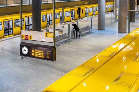 Bundestag underground station with station sign on the platform. Subway line U5. A bottle collector