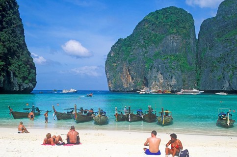 People, longtail boats on Maya Bay beach, known from the movie The Beach, one year in front of the