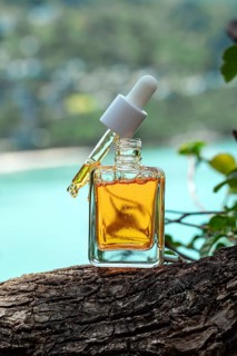 Luxurious cosmetic serum enriched with vitamins and golden particles, carefully positioned on a