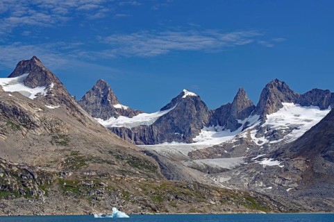 Ragged mountains with snow and blue glaciers under a clear sky, Tasilaq, Arctic, Greenland, Denmark