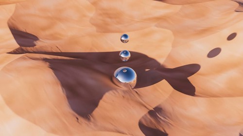 A unique desert landscape showcases smooth dunes with a metallic sphere reflecting vibrant colors