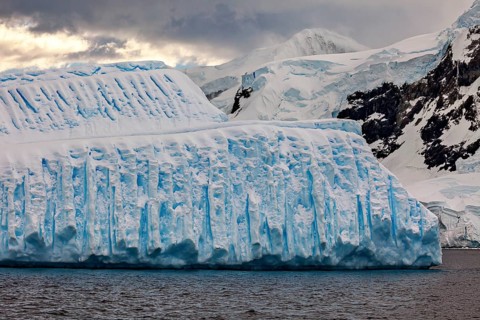 Single massive iceberg against a dark, cloudy backdrop, icebergs in the Southern Ocean in