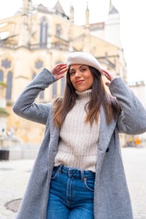 Stylish woman posing smiling at camera in the city in front of a Church