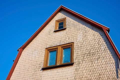 Upper part of a house with gable and windows, framed by a bright blue sky, Erbach, Odenwald, South