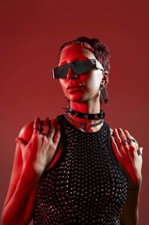 Cyberpunk-inspired female model in futuristic attire, adorned with industrial accessories and edgy