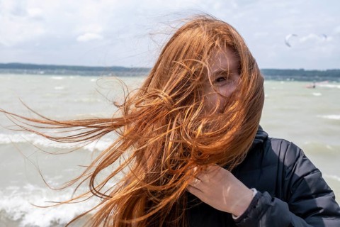 Woman with long hair, wind blowing, storm, wind at Lake Starnberg, east side, Fünfseenland, Upper