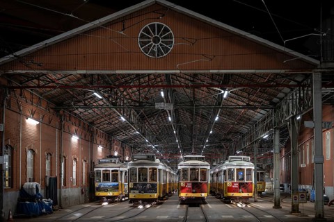 LISBON, PORTUGAL - MAY 19, 2025: Historic trams stand in the tram depot at night