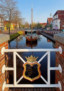 City coat of arms with open-air shipping museum on the main canal, museum ship Frisian Tjalk Thekla