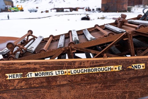 Rusted machine parts with manufacturer's sign Herbert Morris Ltd. Loughborough England, remains of