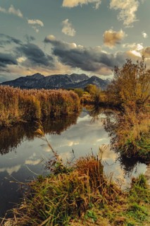 Lake Hopfensee in the Allgäu in autumn with warm sunset light against a picturesque Alpine