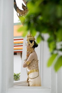 Thai traditionally and festively dressed young woman, Wat Pho, Bangkok, Thailand