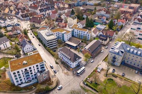 Overview of an urban area with residential and commercial buildings, roads and groups of trees, VHS