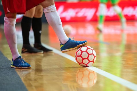 Detail of futsal ball and players legs in Lubin, Poland